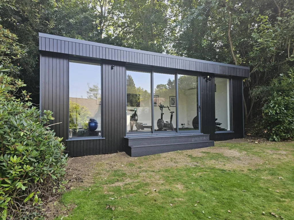 Dark-clad garden building used as a home gym