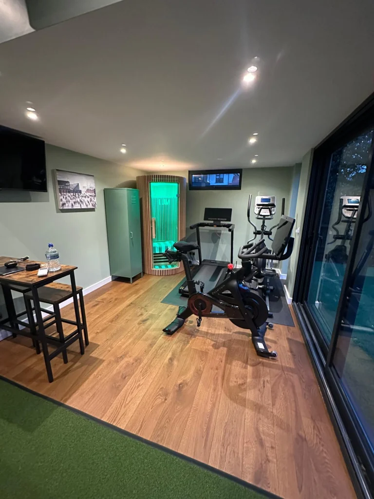 Home gym interior with exercise bike and desk