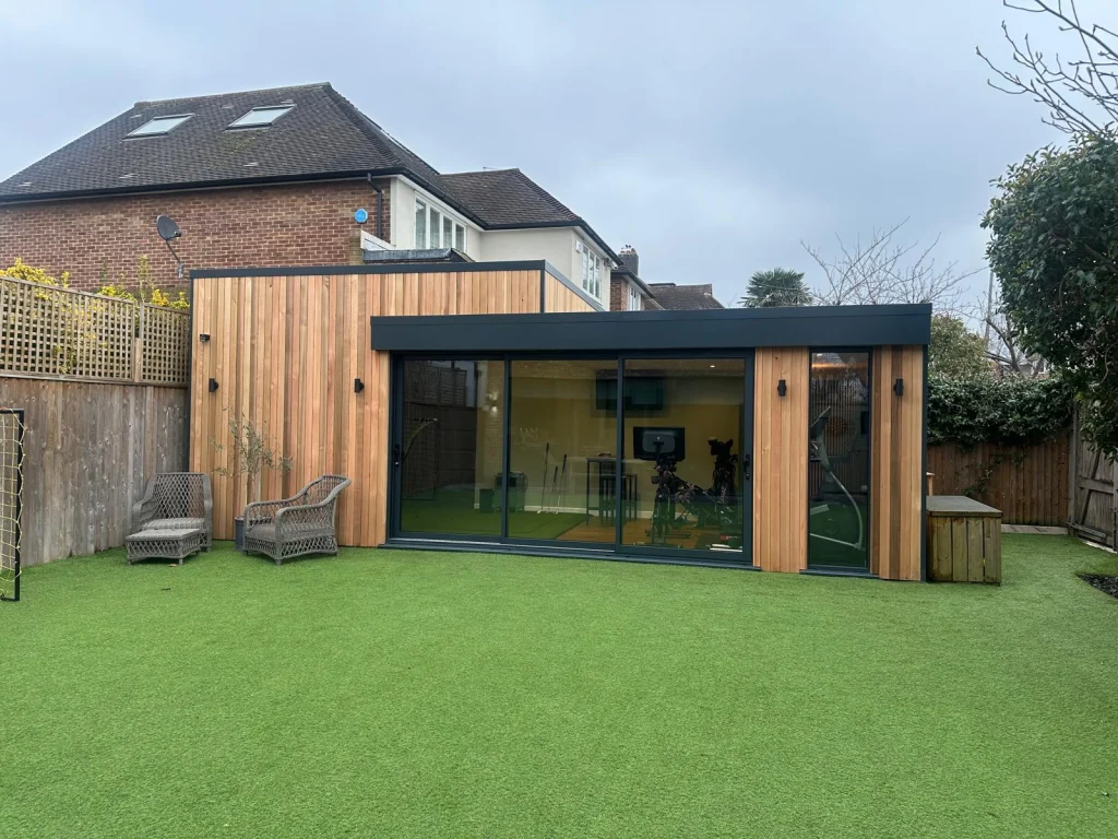 Garden room positioned alongside an existing house and patio
