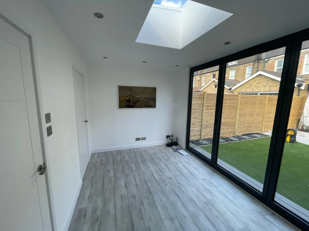 Garden room interior looking out through open glazed doors