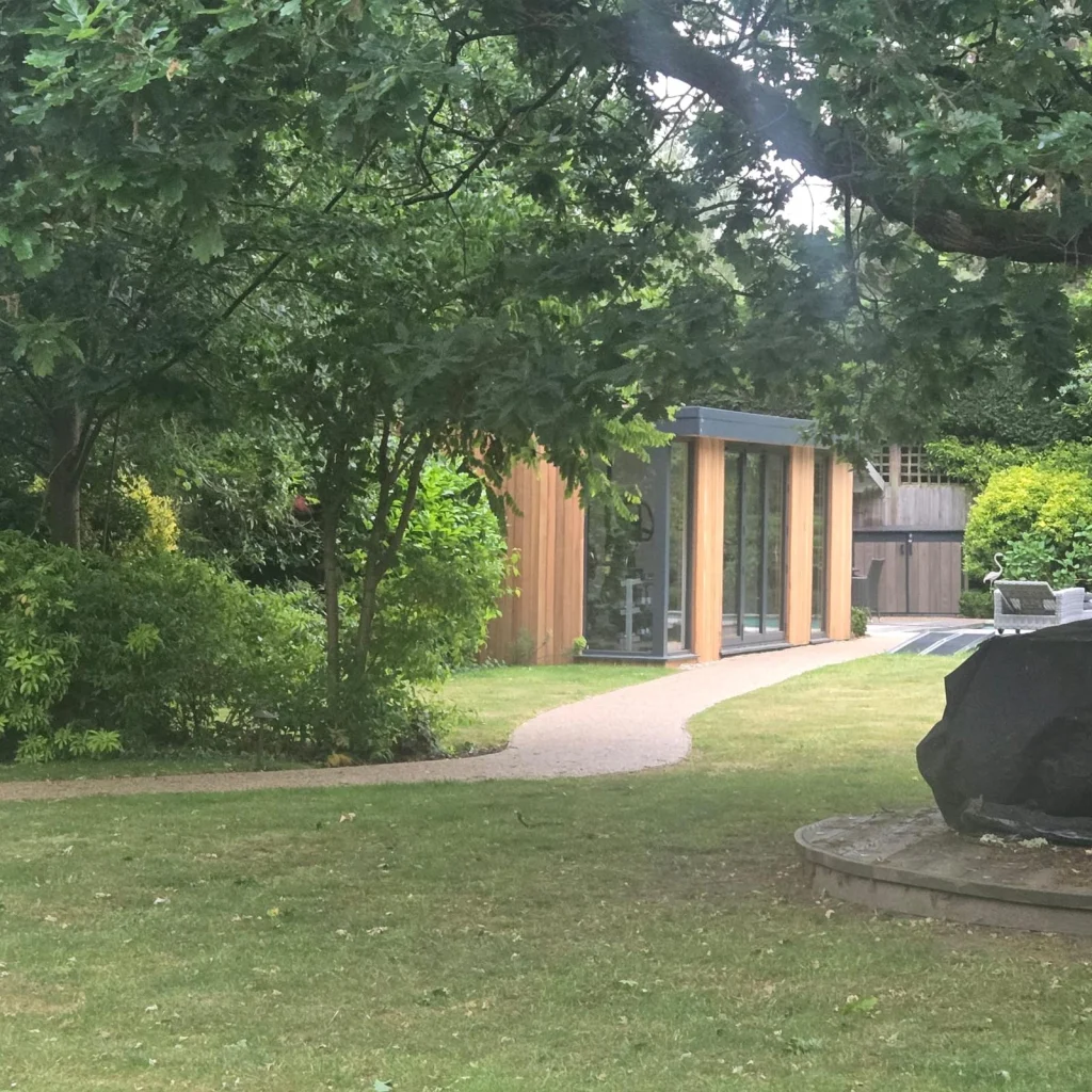 Cedar garden room with full-height glazing in a parkland-style garden