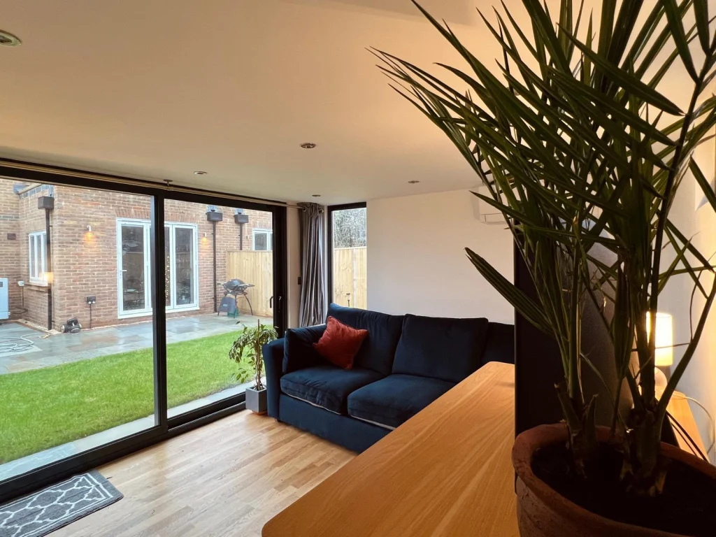 Media room interior with sofa and wall-mounted screen